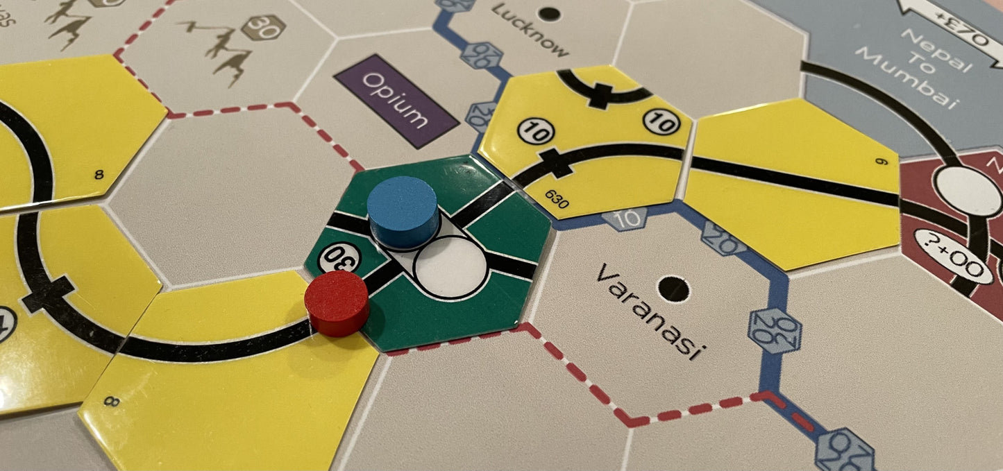 Board game piece on a hexagonal tile with 'Varanasi' labeled