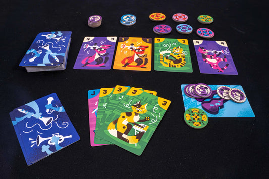 Colorful card game set with cartoon character cards and game pieces on a black surface