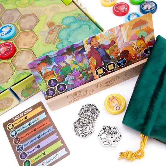 Board game components including cards, pieces, and a box with colorful illustrations on a white background.