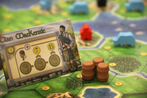 Clans of Caledonia Board game piece with character card and resources on a game board