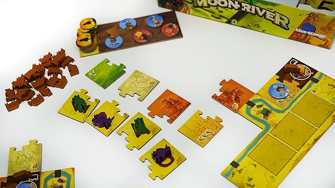 Moon River Board game components including tiles and pieces on a white surface