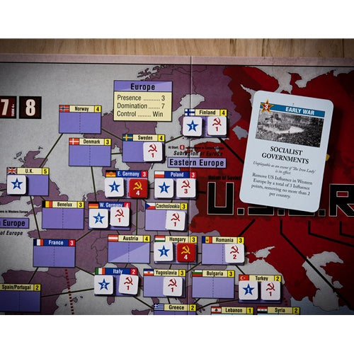 Board game setup with a map of Europe and game pieces on a wooden surface.