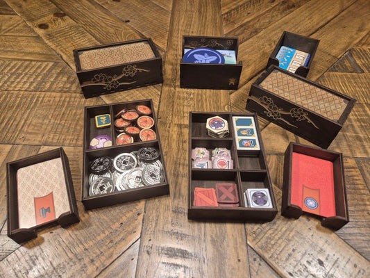 3DLevelup Board game timber organiser with collection of card game components in black boxes on a wooden surface