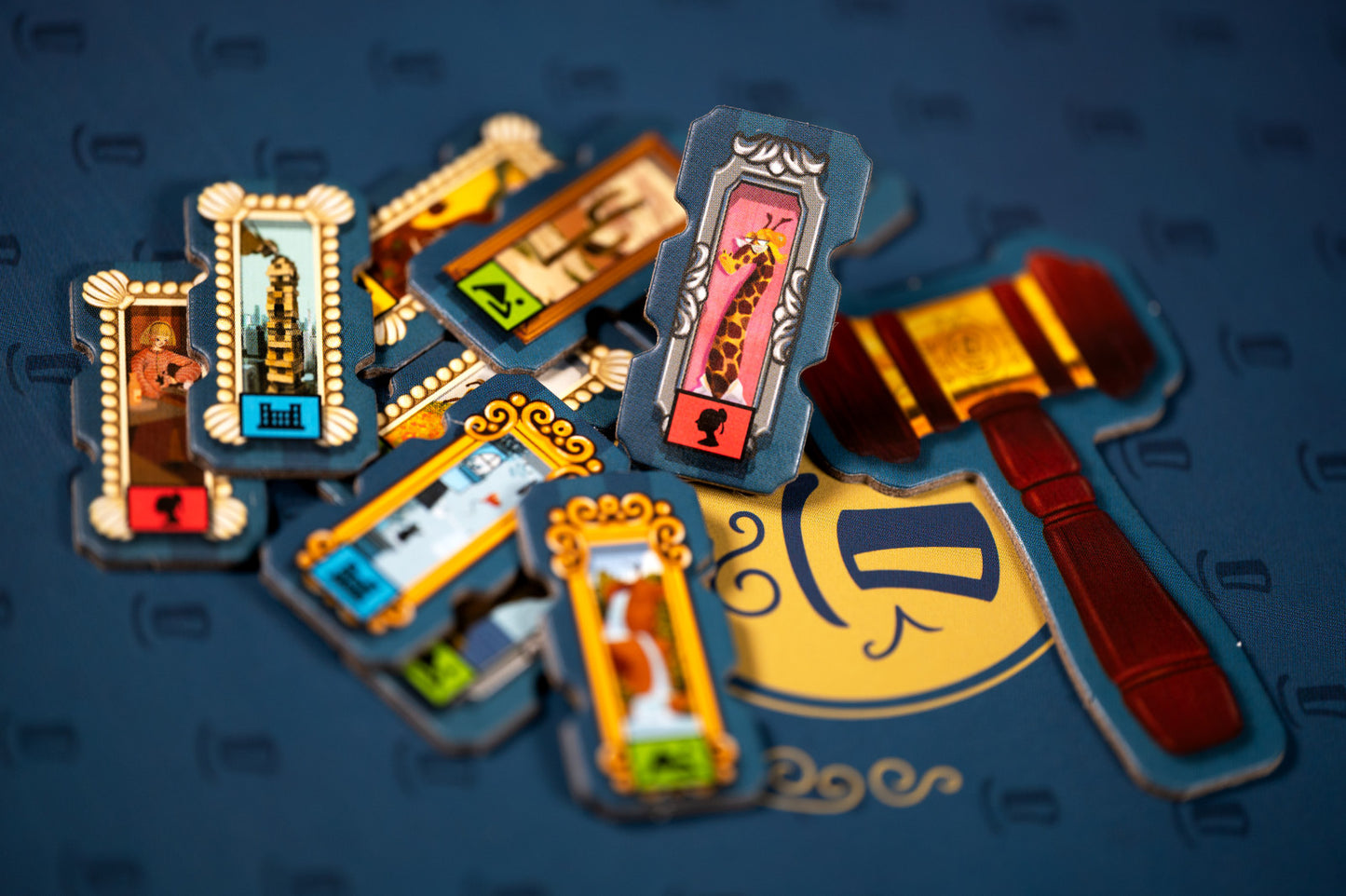 Decorative items including a gavel and framed pictures on a dark background for Art Society the board game