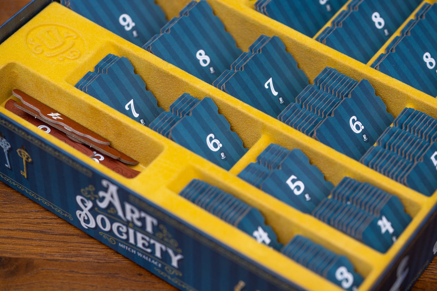 Art Society card game box with blue cards in a yellow organizer