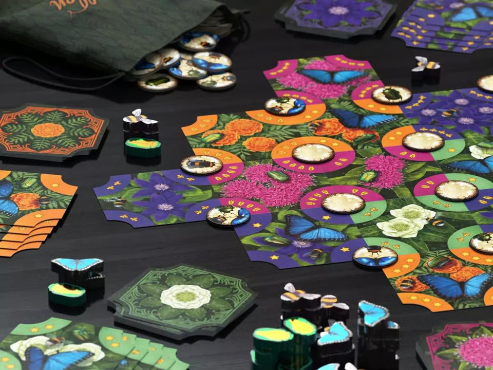 Colorful board game pieces and hexagonal boards on a dark surface
