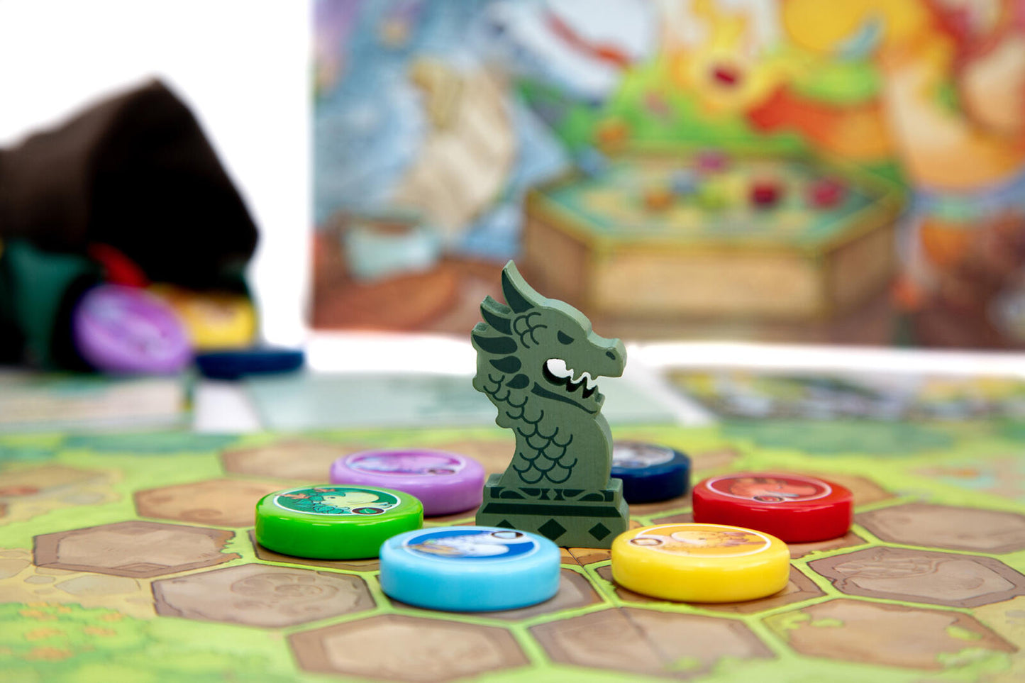 Board game Flamecraft duals piece with dragon design on a colorful game board