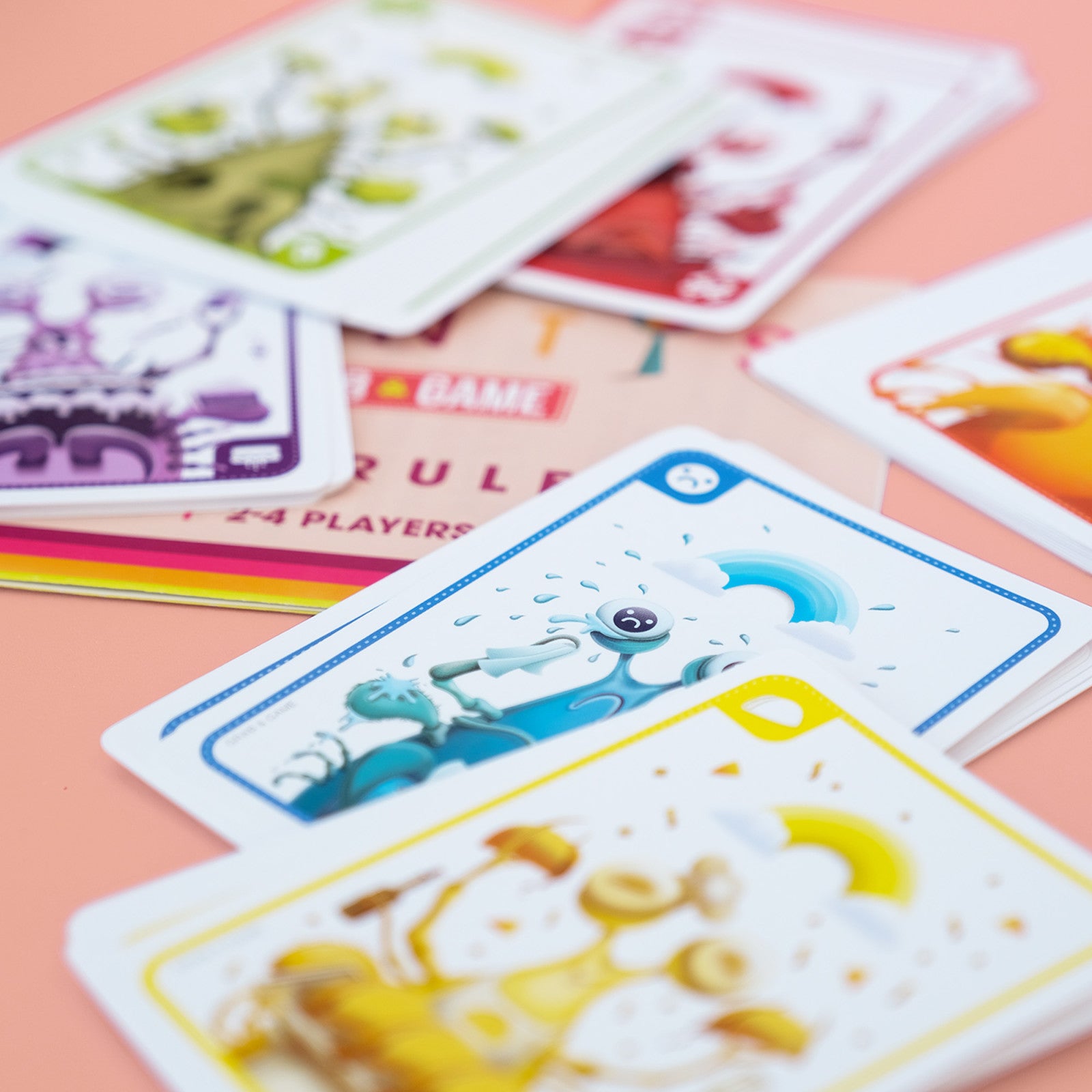 Mantis Colorful playing cards with various designs on a pink surface