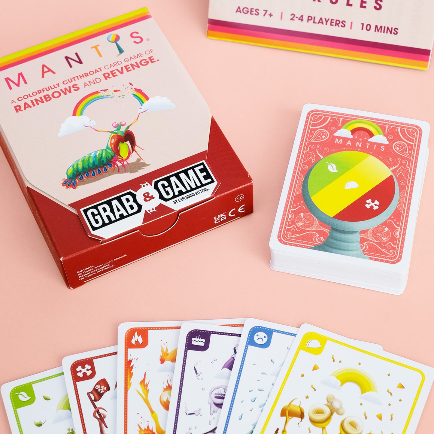 Mantis Board game packaging and cards on a pink background