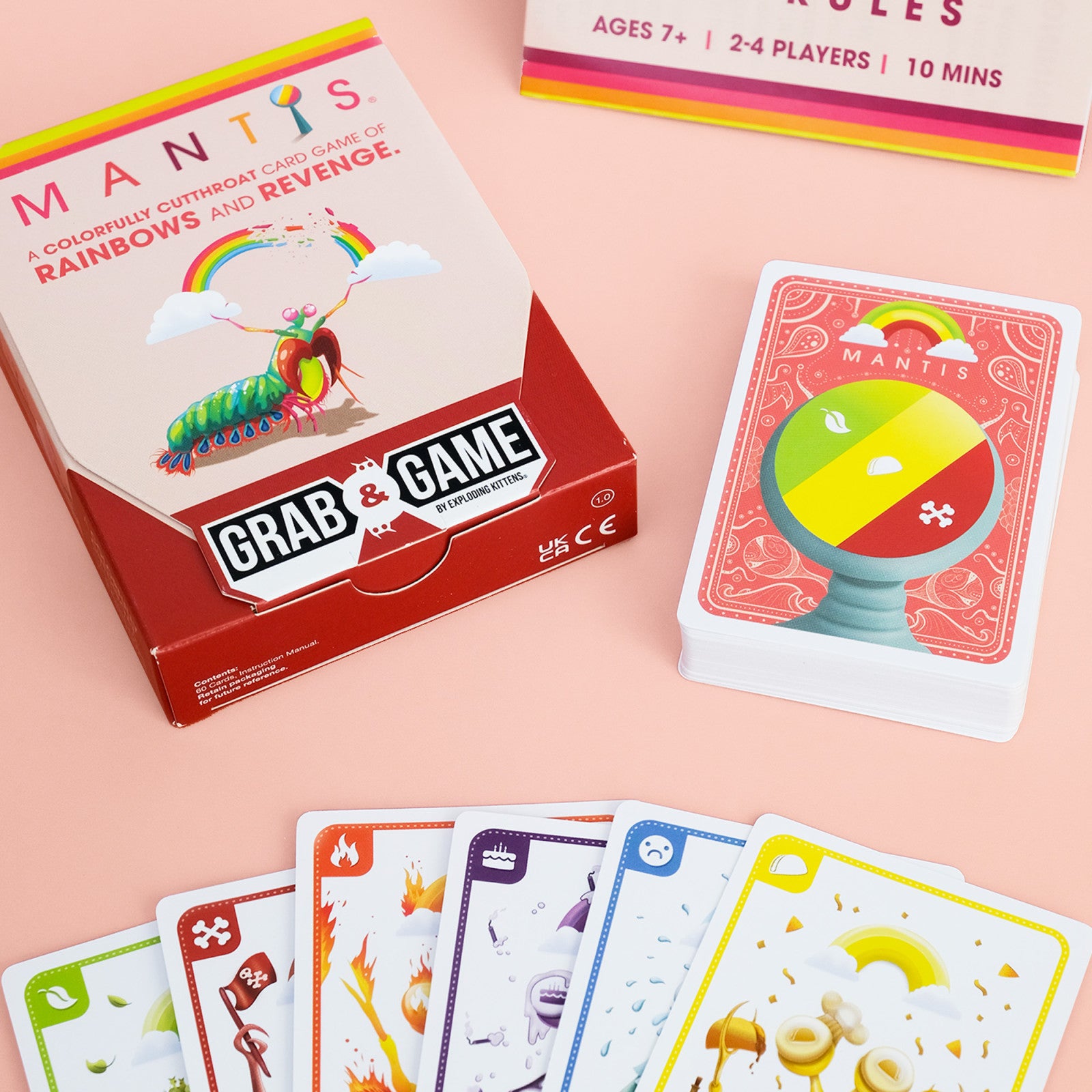 Mantis Board game packaging and cards on a pink background
