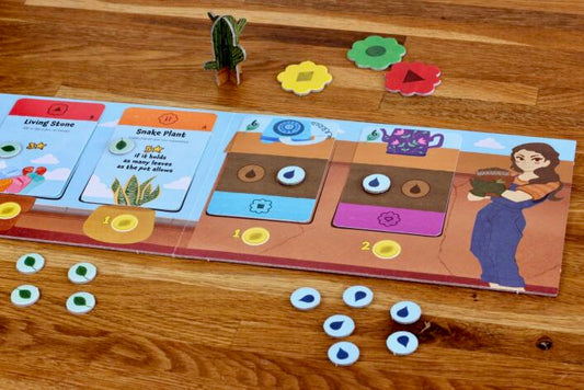 Board game with colorful tiles and character illustration on a wooden surface