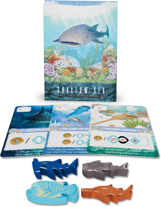 Board game components including cards and fish-shaped tokens with a 'Shallow Sea' box in the background.