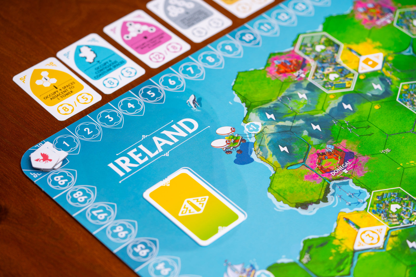 Rebirth Board game with a map of Ireland and player cards on a wooden table