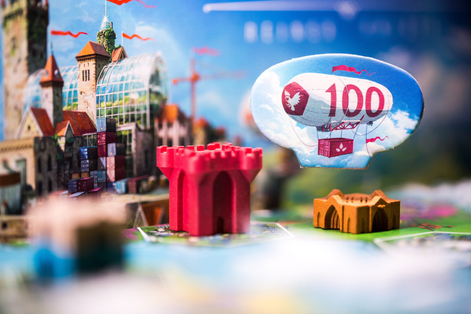 Rebirth Toy cityscape with a red castle, green grass, and a toy balloon with number 100.