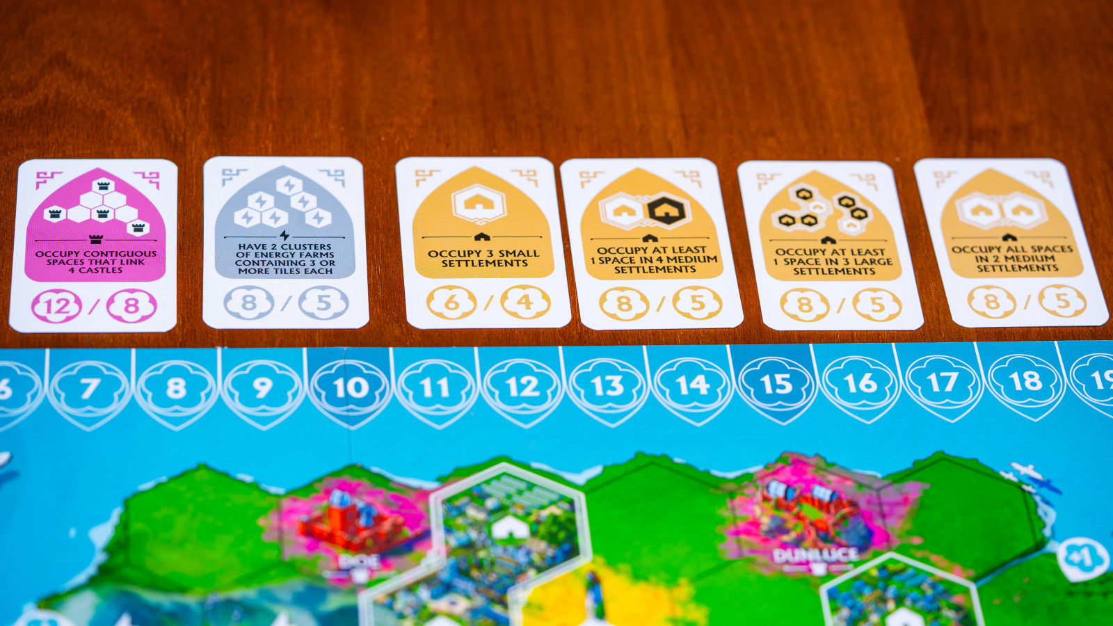 Rebirth Board game cards with colorful designs on a wooden table
