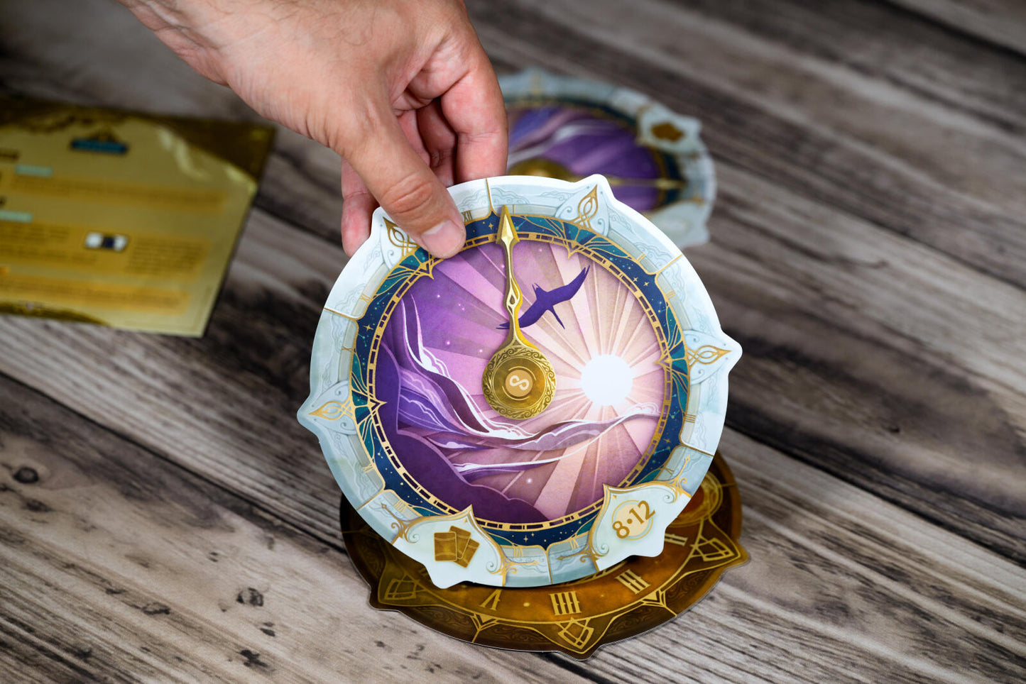 Take Time board game with Decorative circular object with artistic design held by a hand on a wooden surface