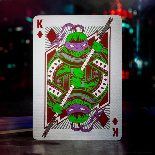 Playing card with a green character design on a dark background