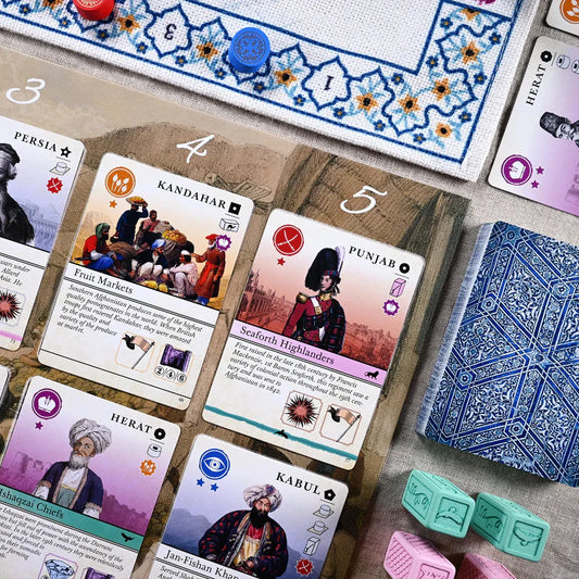 Pax Pamir Board game cards with illustrations and text on a wooden board