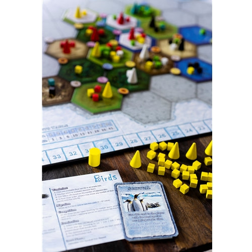 Dominant Species game with hexagonal tiles, game pieces, and a card on a wooden surface.