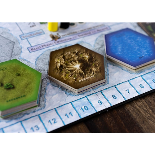Dominant Species Hexagonal game pieces on a board with scenic designs