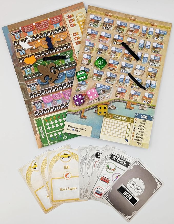 Board game components laid out on a white background, including two illustrated game boards, several dice, black tokens, and multiple player cards with vehicle-themed illustrations.