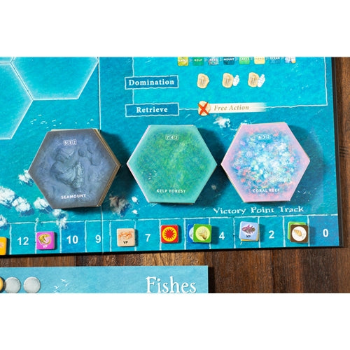 Dominant Species Board game components with hexagonal tiles and game pieces on a blue game board.