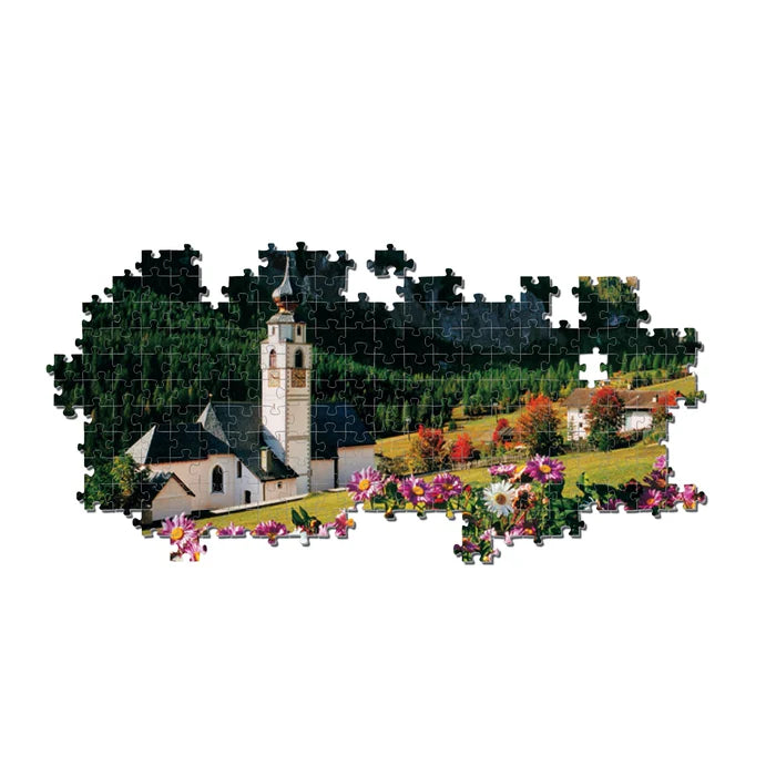 Jigsaw puzzle of a scenic landscape with a church and flowers on a white background