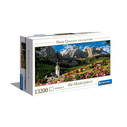 Jigsaw puzzle box with mountain and village scene on a white background