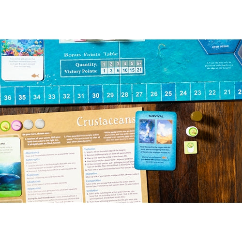 Dominant Species Marine Board game component with a card and markers on a wooden surface