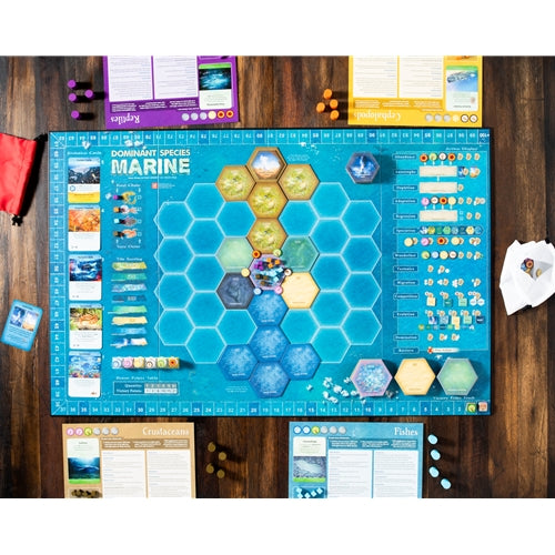 Dominant Species Board game setup with a blue hexagonal grid on a wooden surface