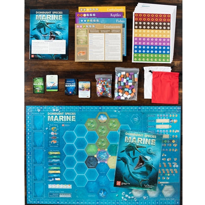 Dominant Species Marine Collection of board game components including cards, dice, and a map on a wooden surface.