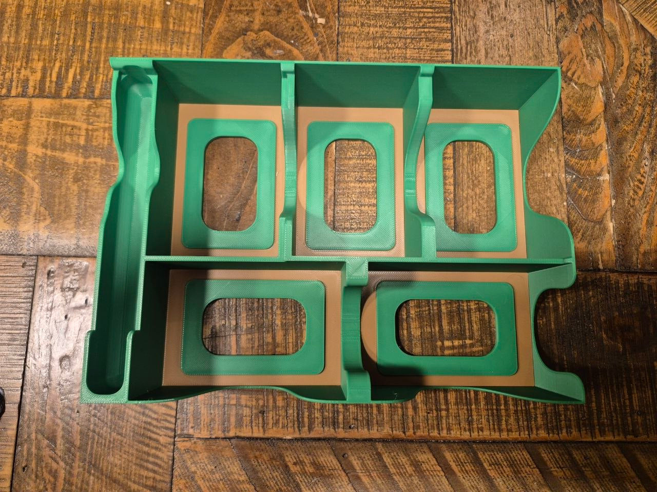 Forest shuffle organiser tray with five deck compartments, shown on a dark wood plank surface.