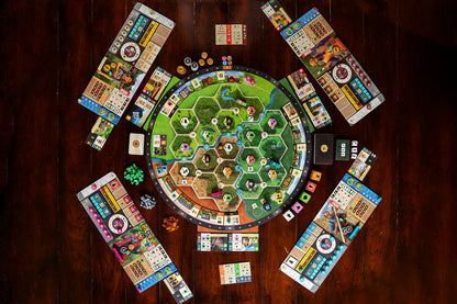 Forestry Board game with colorful tiles and a central board on a wooden table
