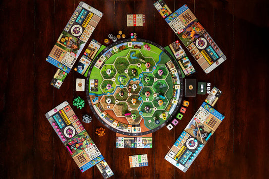 Forestry Board game with colorful tiles and a central board on a wooden table