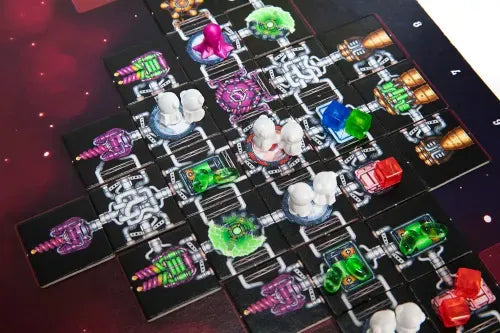 Galaxy Trucker game with colorful pieces on a dark surface