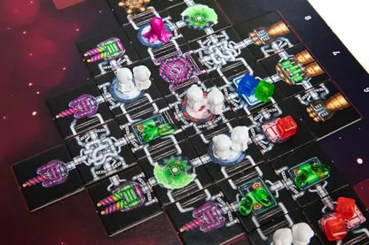 Galaxy Trucker game with colorful pieces on a dark surface