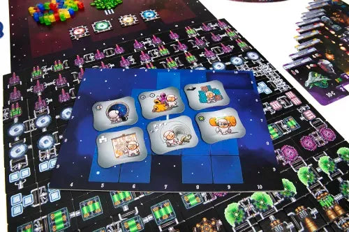 Galaxy Trucker Board game with colorful tiles and player cards on a dark surface