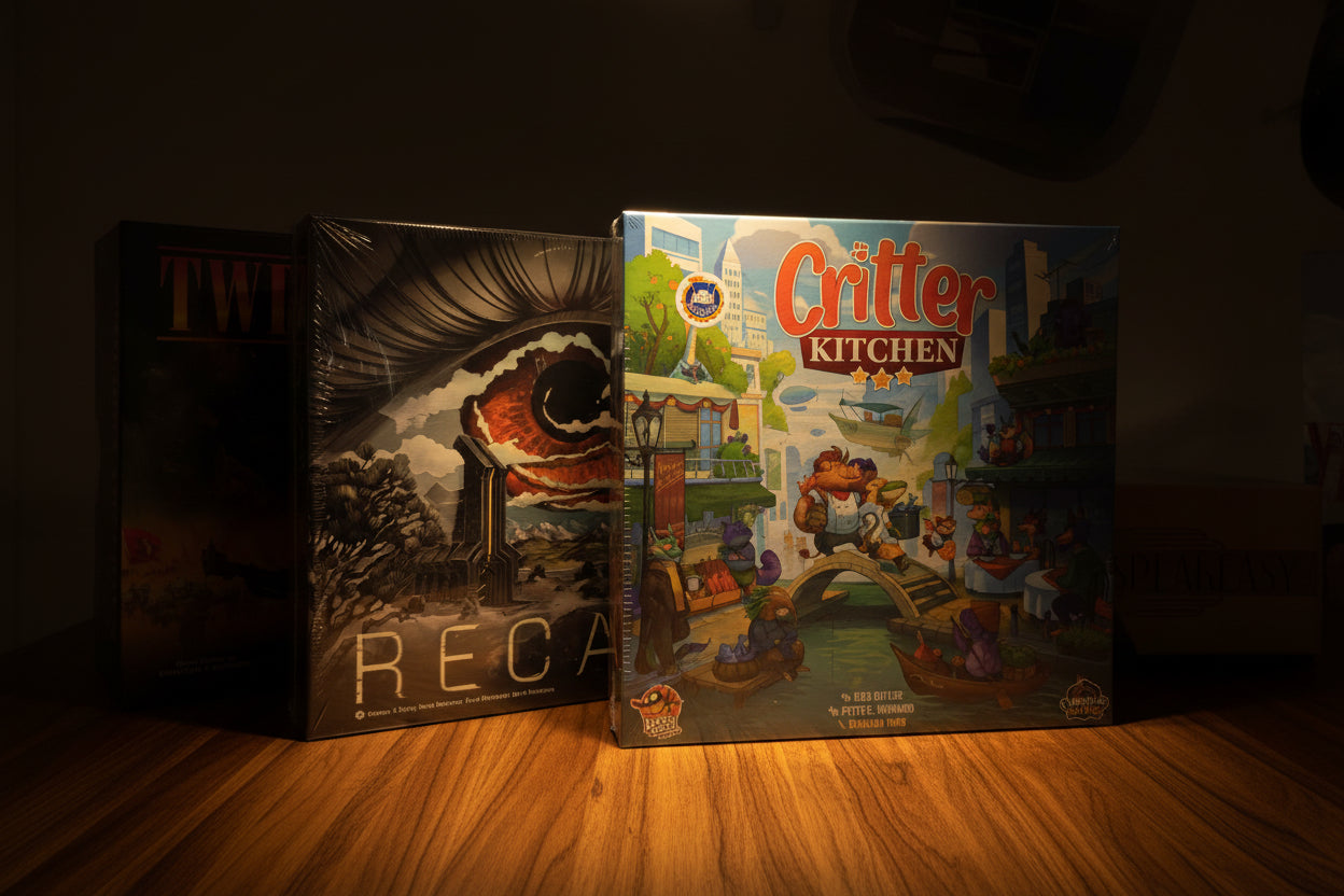 Board game boxes including 'Twilight Struggle', 'Regalia', and 'Critter Kitchen' on a gray surface.