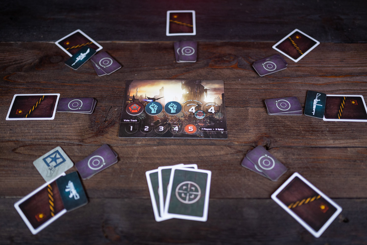 Card game setup on a wooden table with various cards spread out.