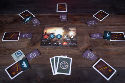 Card game setup on a wooden table with various cards spread out.