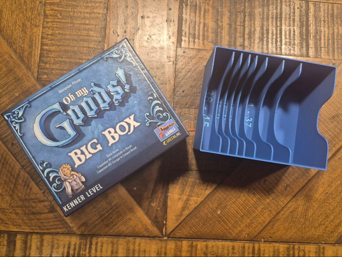 A blue plastic card tray organizer and its branded box from The Game of Thrones 'Bronze Age' set, placed on a wooden floor.