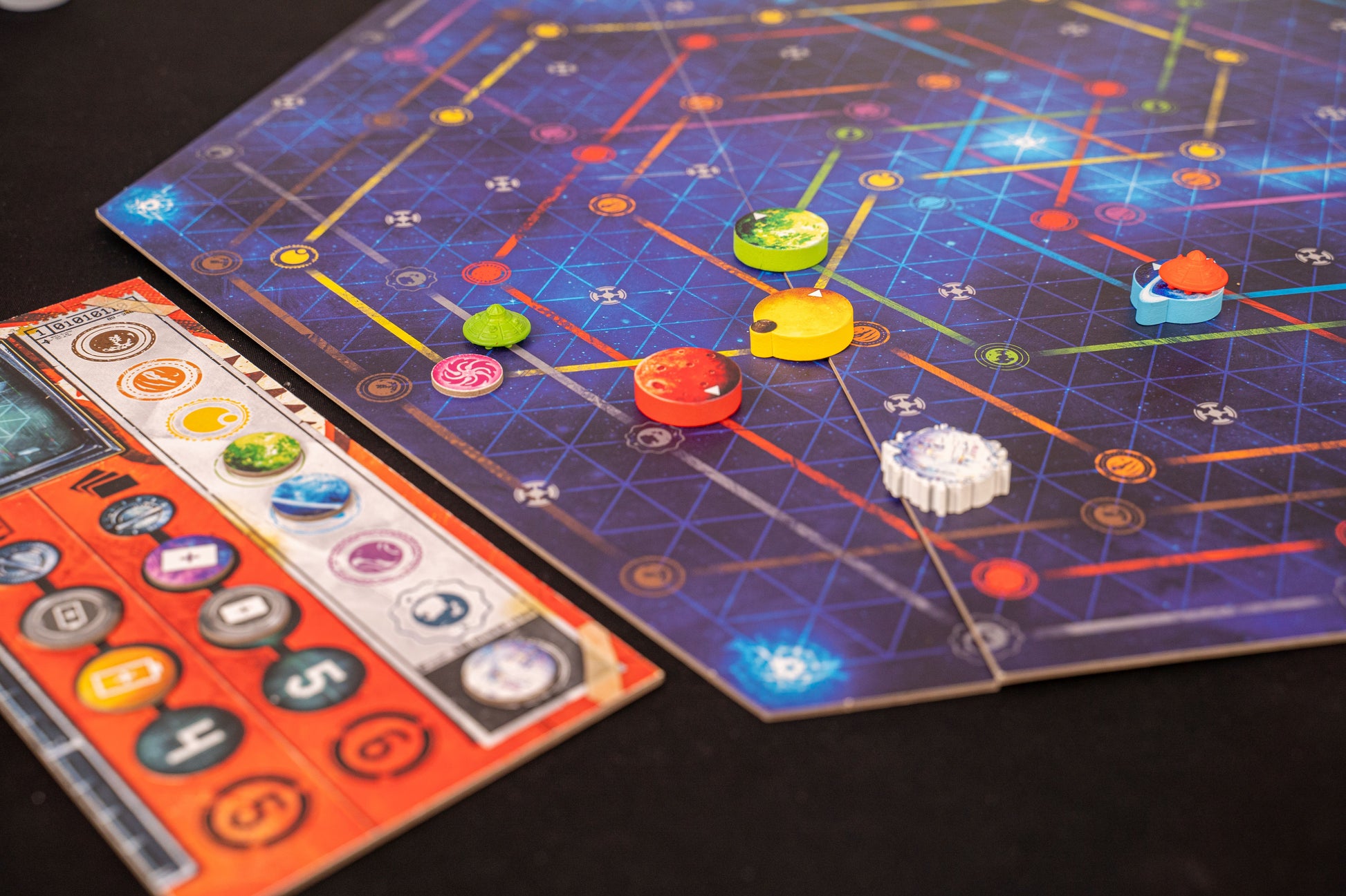 Orbit Board game with colorful pieces on a grid-patterned board