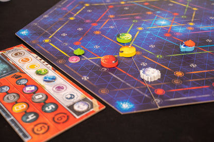 Orbit Board game with colorful pieces on a grid-patterned board