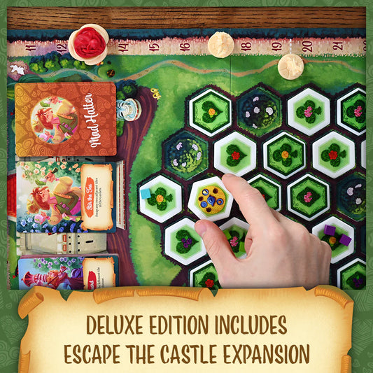 Paint the Roses Board game with hexagonal tiles and a hand placing a tile, featuring 'Mad Hatter' and 'Alice in Wonderland' books.