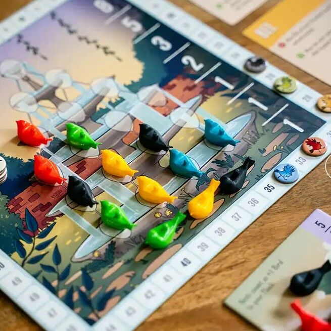 Board game with colorful player pieces on a scenic board