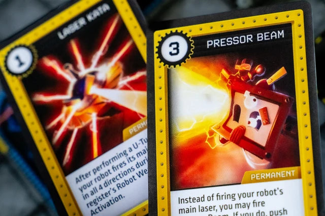 Robo Rally Two trading cards with vibrant graphics and text on a blurred background