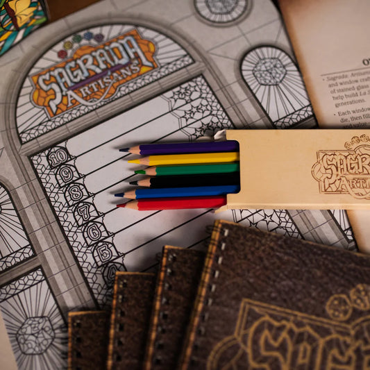 Coloring book with 'Sagrada Familia' design and colored pencils on top