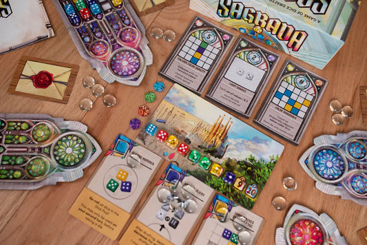 Board game components including cards and pieces on a wooden surface
