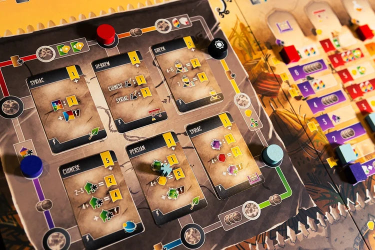 Scholars of the South Tigris Close-up of a board game with card holders and game pieces.