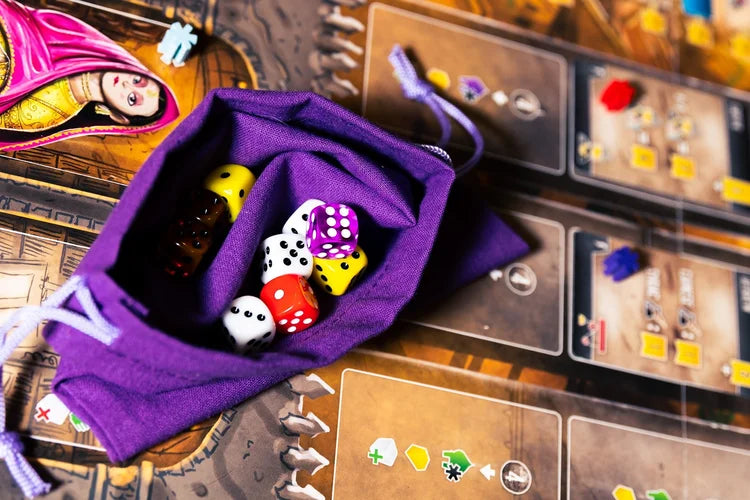 Scholars of the South Tigris Purple drawstring bag with dice on a board game surface